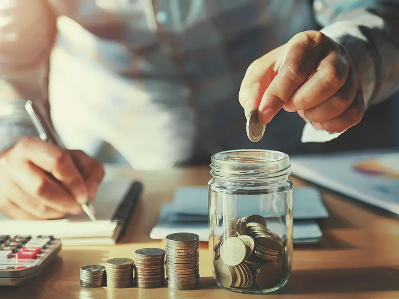 hand putting change in jar