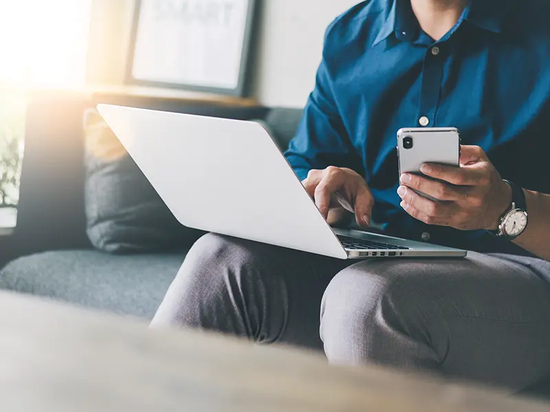 person holding credit card on laptop