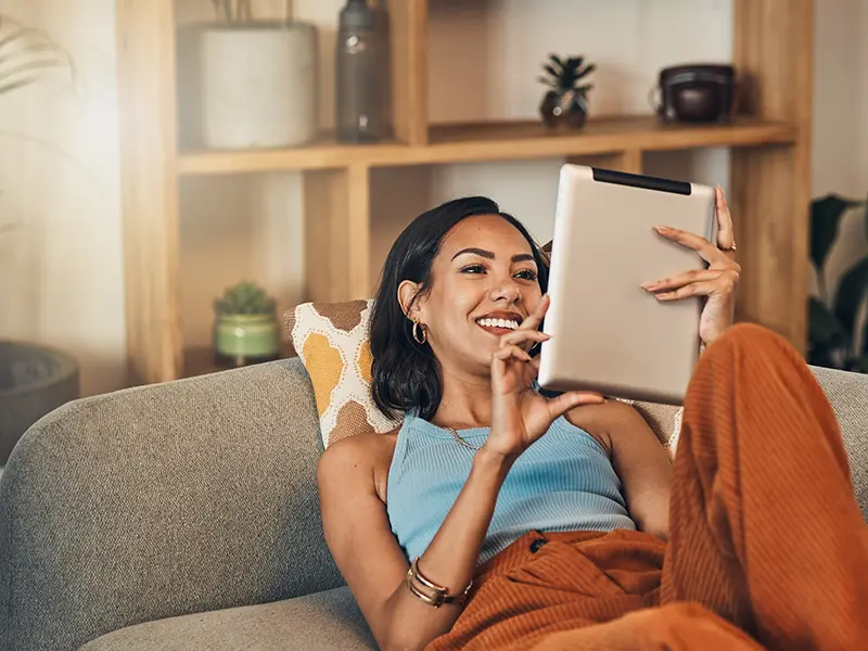 woman on couch with tablet